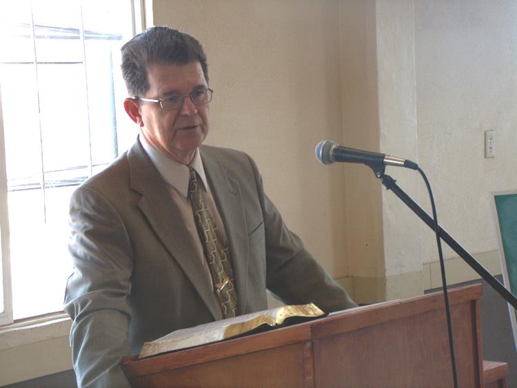 Tim Hendricks speaking at a podium