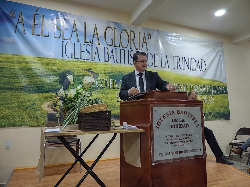 Tim Hendricks preaching from the pulpit